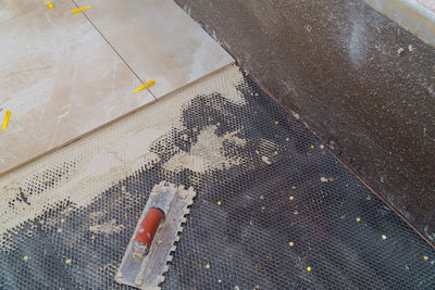 High angle view of metal grate on bed