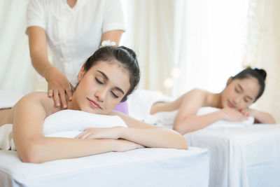 Young woman receiving massage in spa