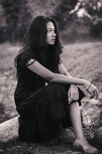 Young woman sitting on field