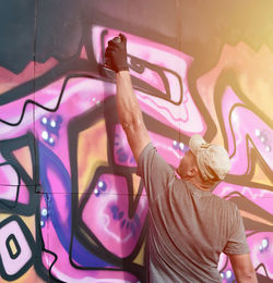 Low angle view of woman with arms raised