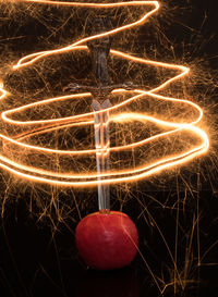 Low angle view of illuminated christmas lights against black background