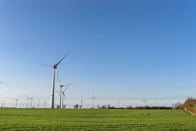 Wind turbines for the production of electricity from wind in a field in western germany.