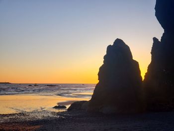 Scenic view of sea against clear sky during sunset