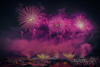 Low angle view of firework display at night