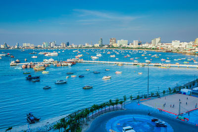 High angle view of city by sea against sky