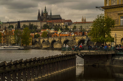 Buildings in city against cloudy sky