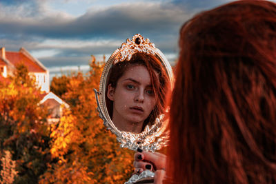 Portrait of woman against sky during autumn