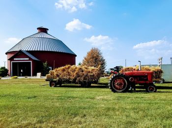 Tractor on field against sky