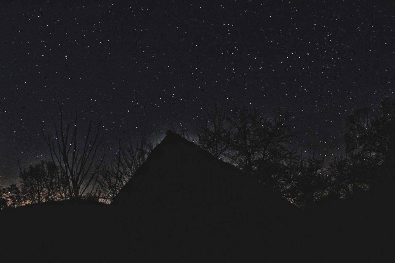 LOW ANGLE VIEW OF BUILDING AGAINST STAR FIELD AT NIGHT