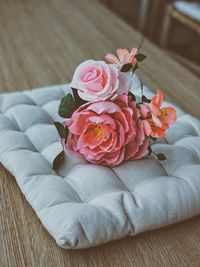 Close-up of pink rose on table