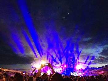 People watching firework display at night