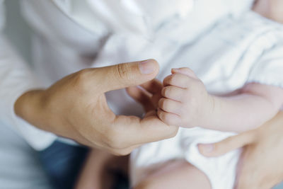 Midsection of woman holding hands