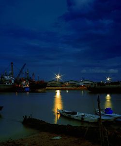 Boats in harbor at night