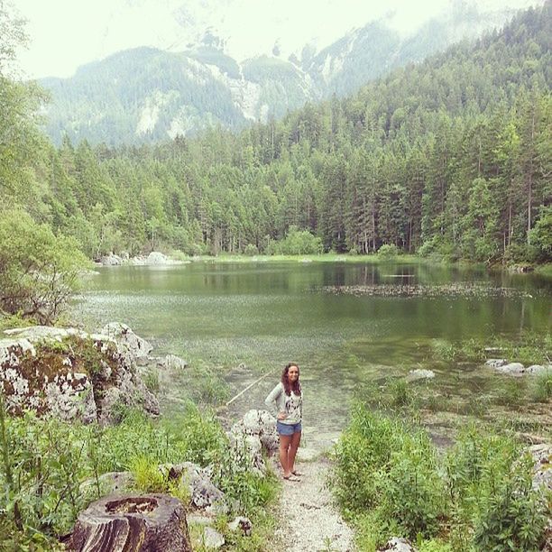 water, tranquility, tranquil scene, leisure activity, lifestyles, tree, scenics, beauty in nature, nature, lake, mountain, rear view, sitting, full length, men, river, rock - object, person