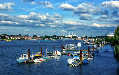 Boats in river with city in background