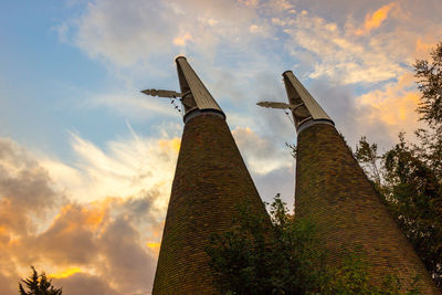 Low angle view of factory against sky