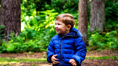 Portrait of boy against trees