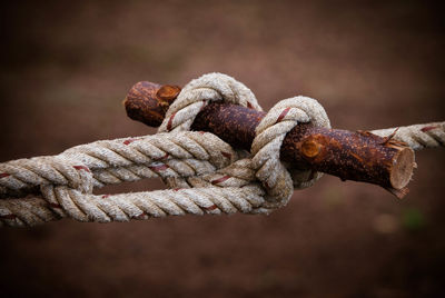 Close-up of rope tied on rusty metal