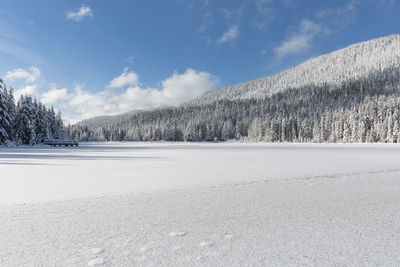 Snow covered landscape against sky