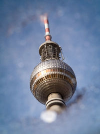 Low angle view of tower against cloudy sky