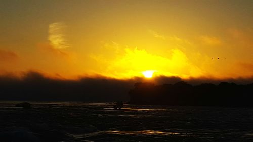 View of calm beach at sunset