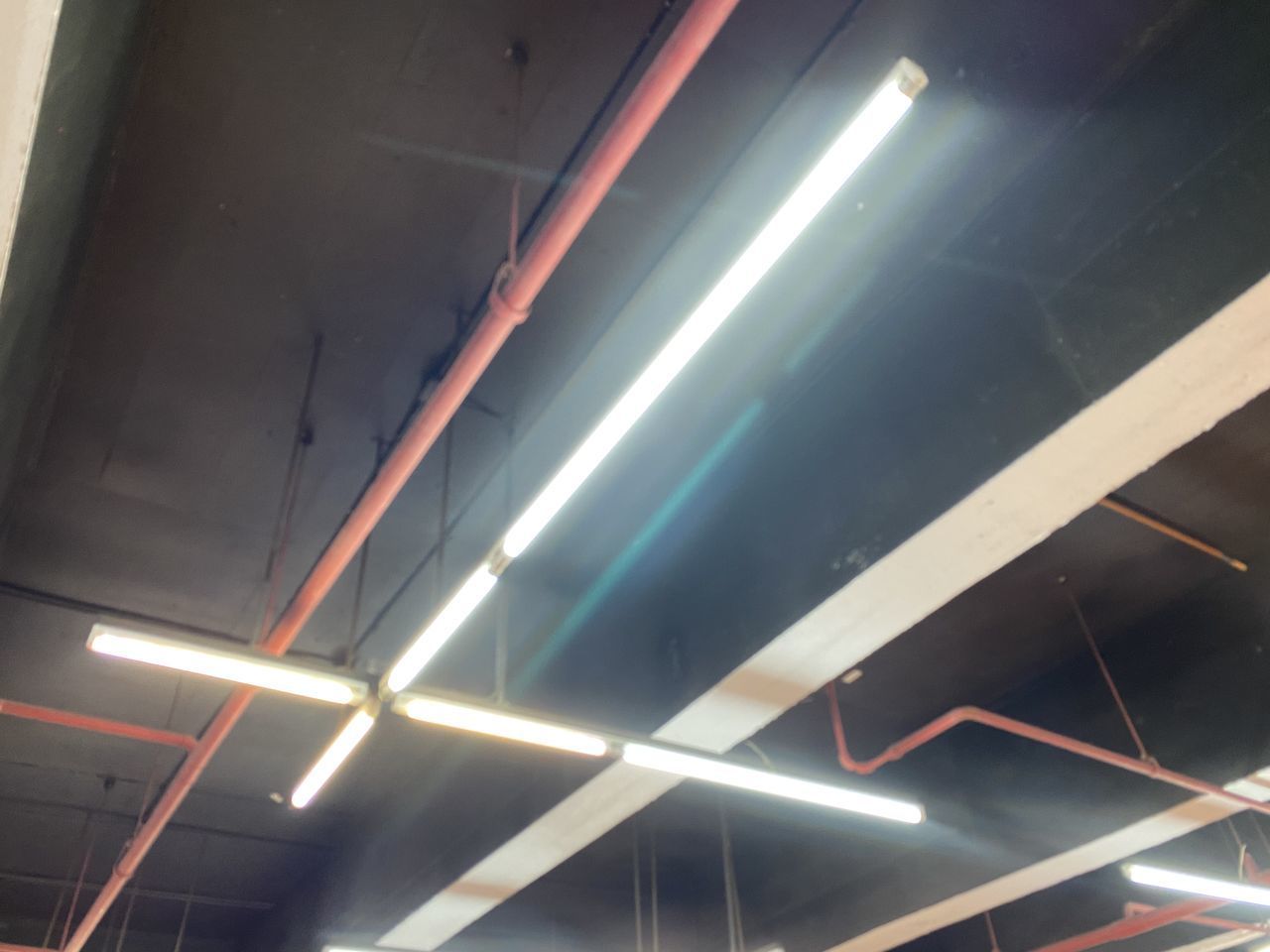 LOW ANGLE VIEW OF ILLUMINATED LIGHT AT CEILING