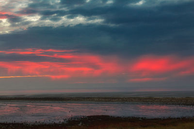 Scenic view of dramatic sky over sea during sunset