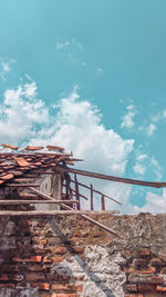 Low angle view of abandoned building against sky