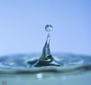 Close-up of drop falling on water