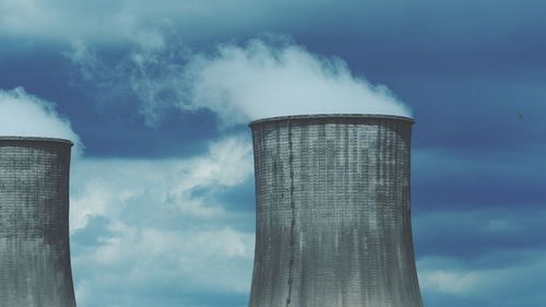 Low angle view of smoke stack against sky