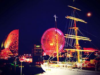 Illuminated ferris wheel at night