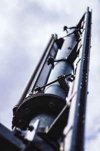 Low angle view of metal pole against sky