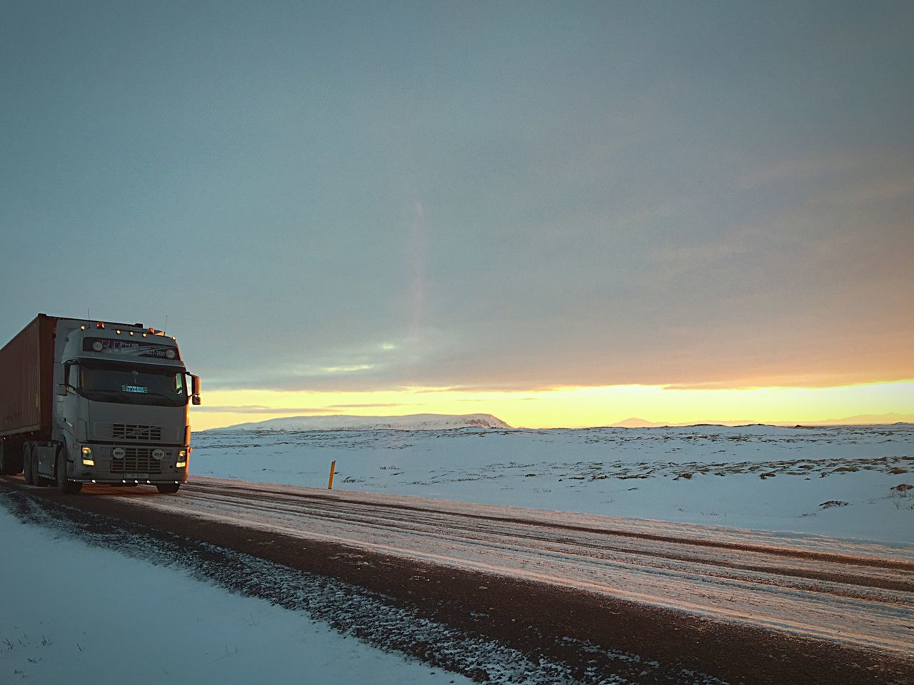 winter, snow, cold temperature, sunset, transportation, season, sky, weather, mode of transport, nature, covering, tranquil scene, road, scenics, beauty in nature, tranquility, orange color, copy space, outdoors, dusk