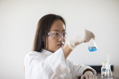 Scientist female with sample and tubes in a lab