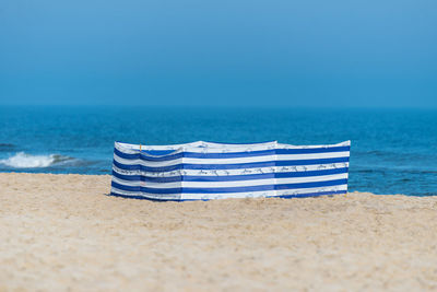 Beach screen on the polish beach on a sunny summer day in the background beautiful sea.