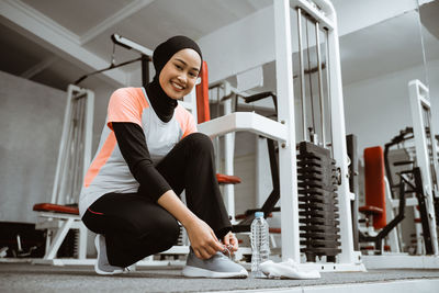 Young woman exercising in gym