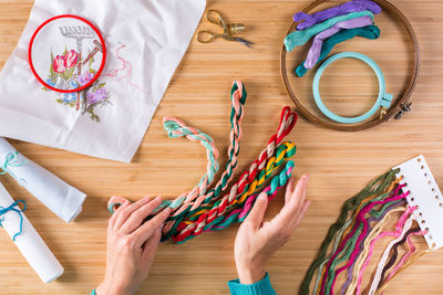 Directly above view of intertwined multi colored wool on table