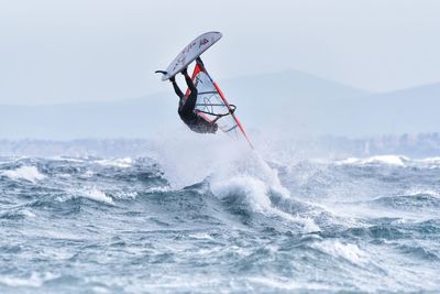 Man with umbrella on sea