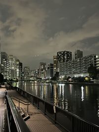 Illuminated buildings against sky at night