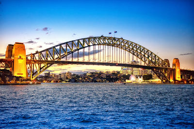 View of bridge over river at sunset