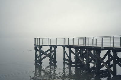 Pier over sea against clear sky