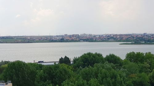 High angle view of river by city against sky