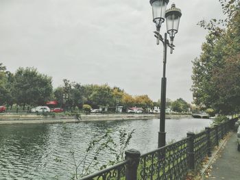 View of calm lake against cloudy sky