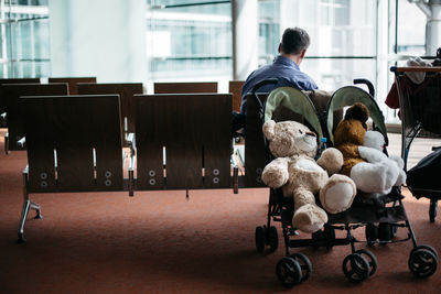 Teddy bears in baby stroller at airport