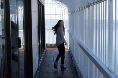 Young woman standing at home