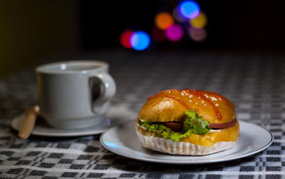 Close-up of burger and coffee on table