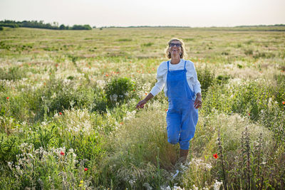 Rear view of woman standing on field