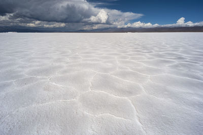 View of salt beach under cloudy sky