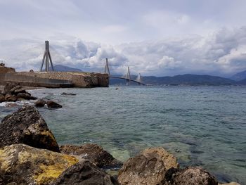 Sailboat on sea shore against sky