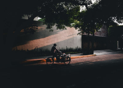 Man riding bicycle on street in city